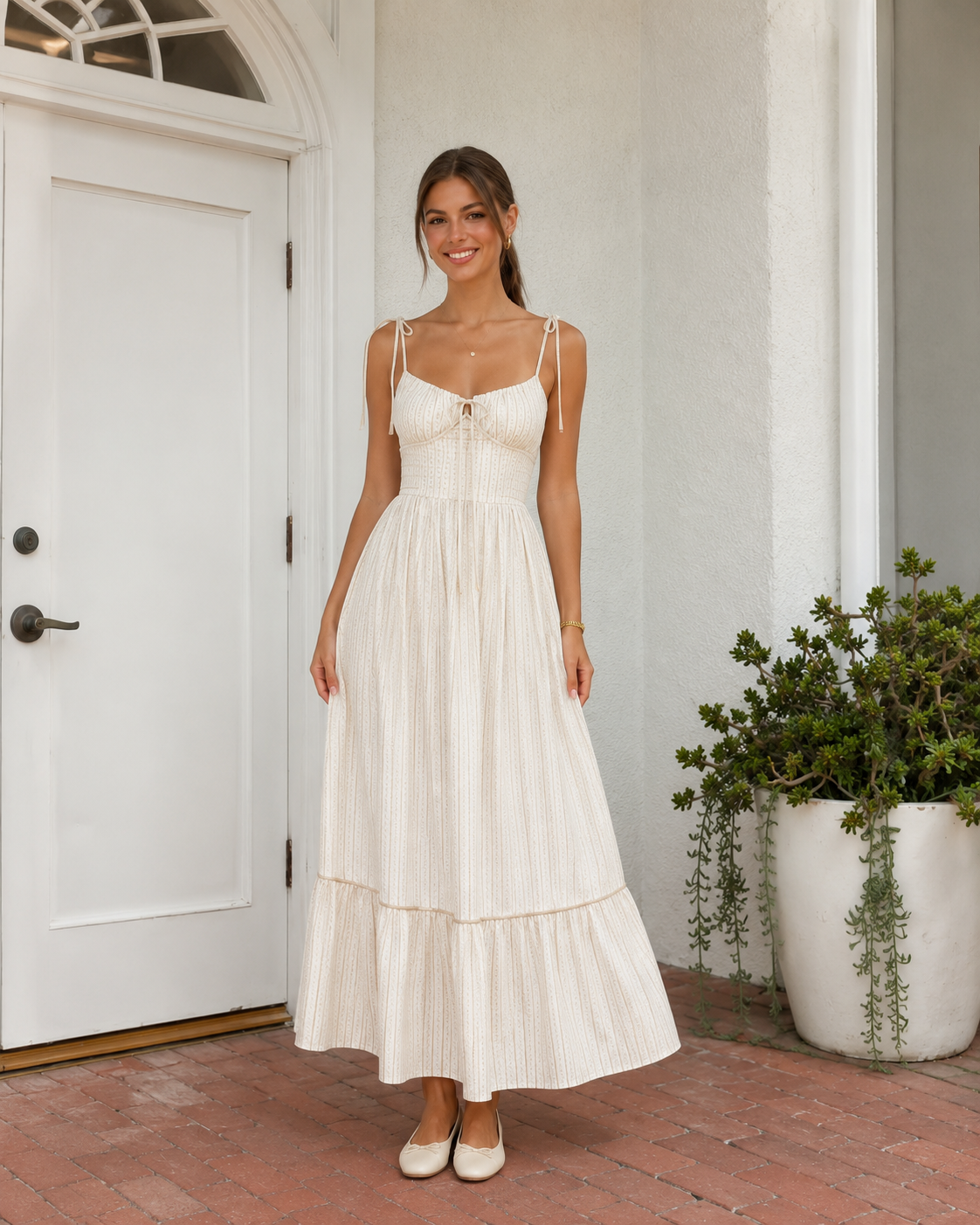 Cream tie-shoulder maxi dress with textured stripe pattern and long flowing skirt front view