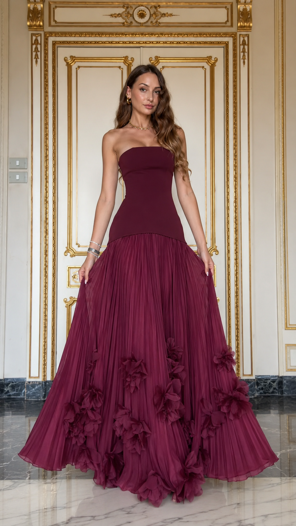 Front view of burgundy strapless evening gown with fitted bodice and flowing skirt