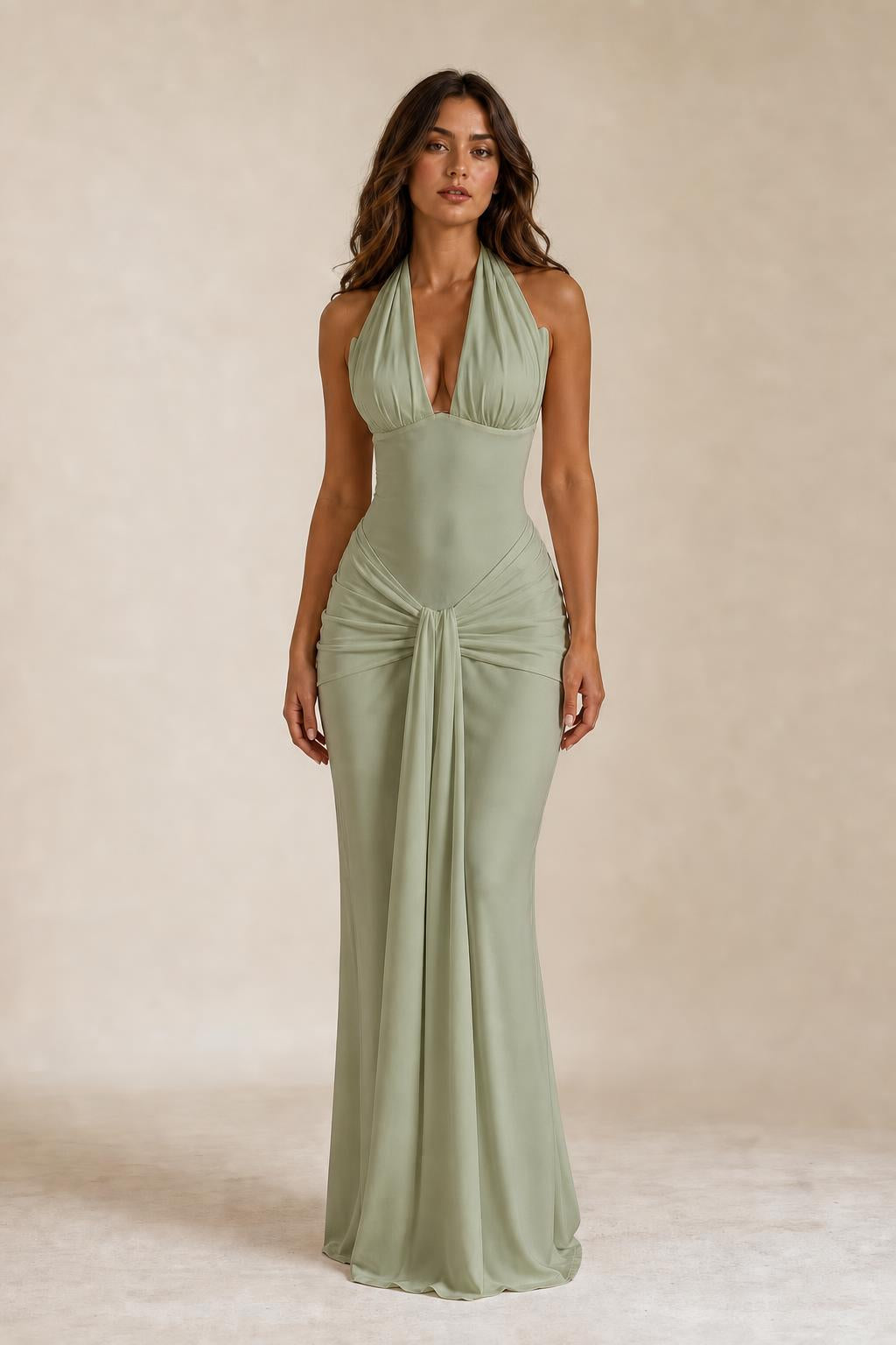 Front view of woman wearing sage green draped halter neck maxi dress