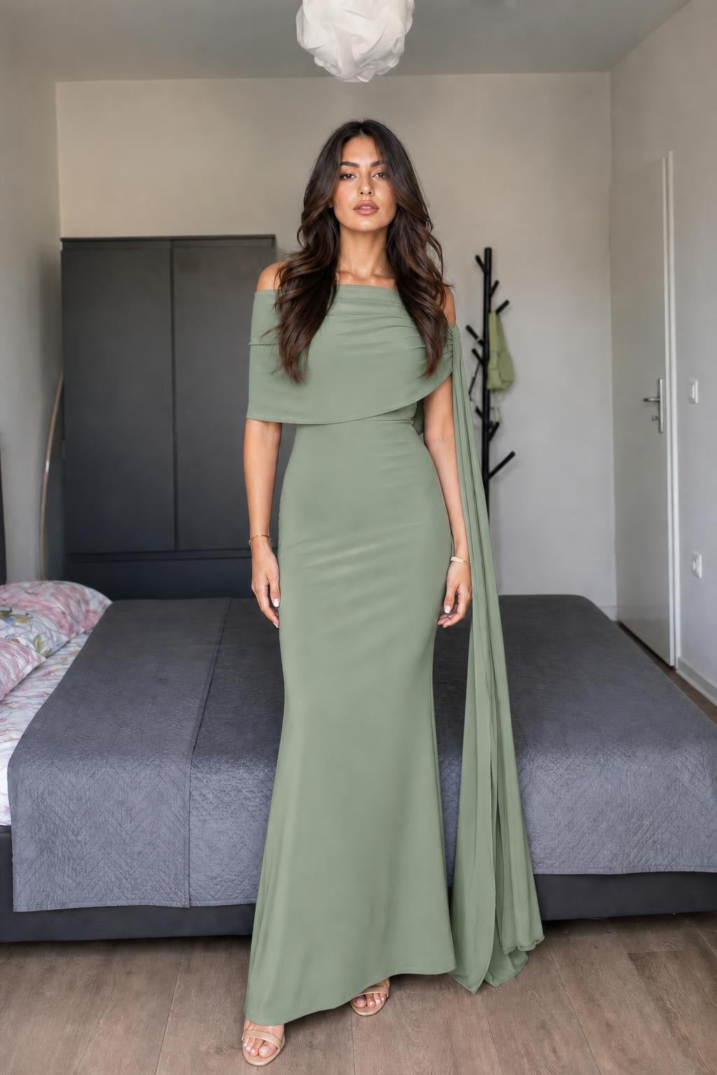 Model wearing sage green off-shoulder cape maxi dress