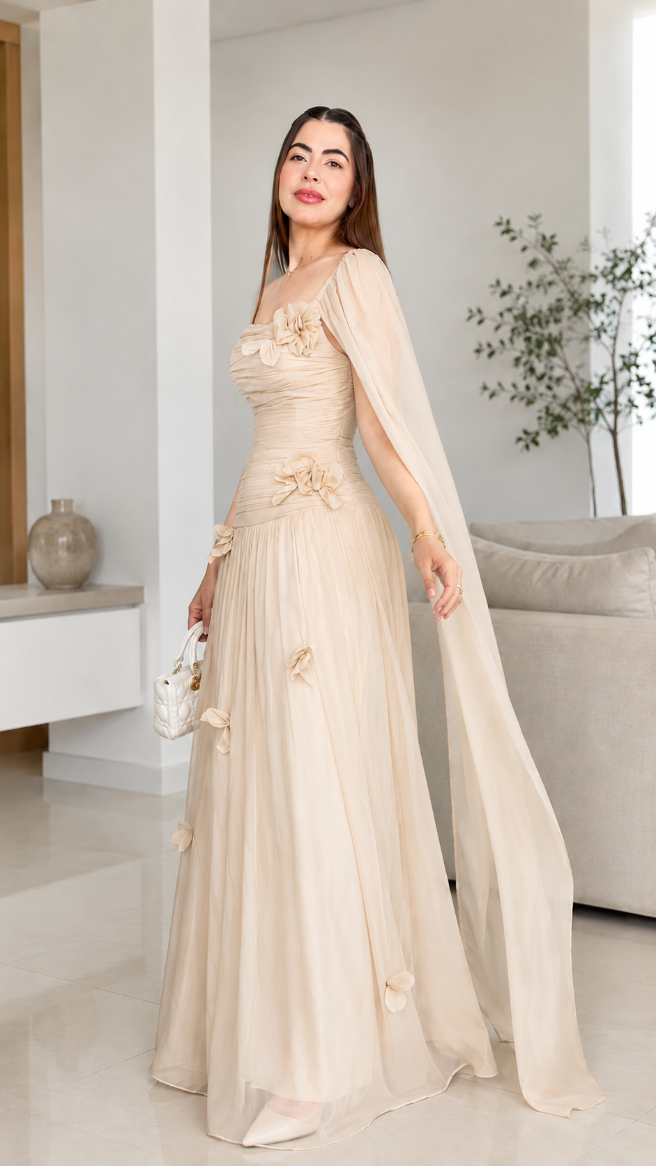 Champagne one-shoulder maxi dress with floral appliqué and soft flowing hem