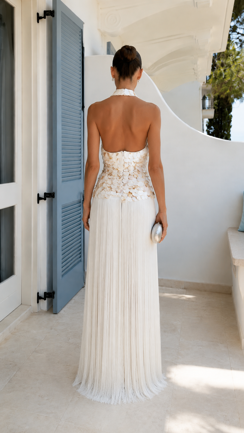 Back view of ivory halter evening dress with open back and pleated maxi skirt