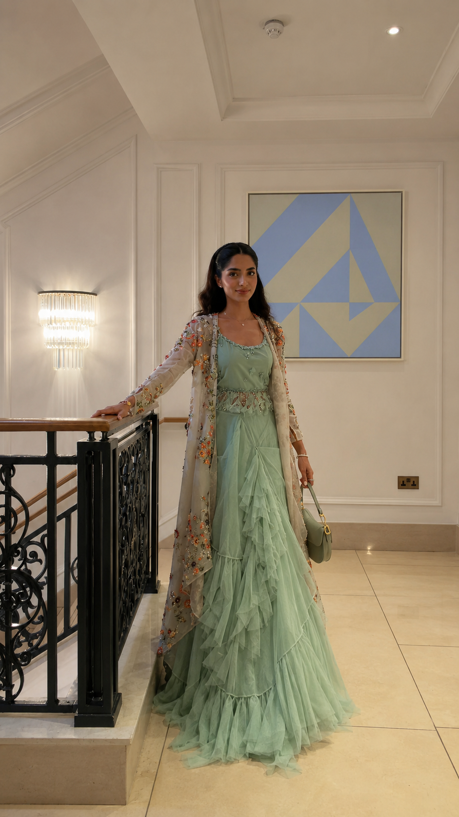 Front view of the mint green embroidered cape gown set with full-length ruffle skirt
