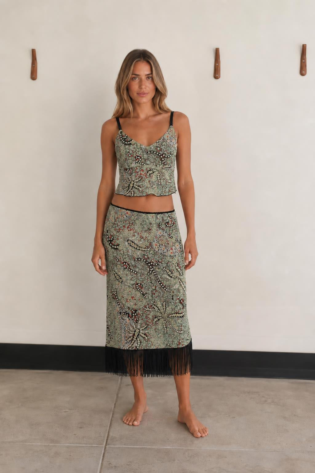 Front view of woman wearing Green Multi paisley crop top and fringe skirt set