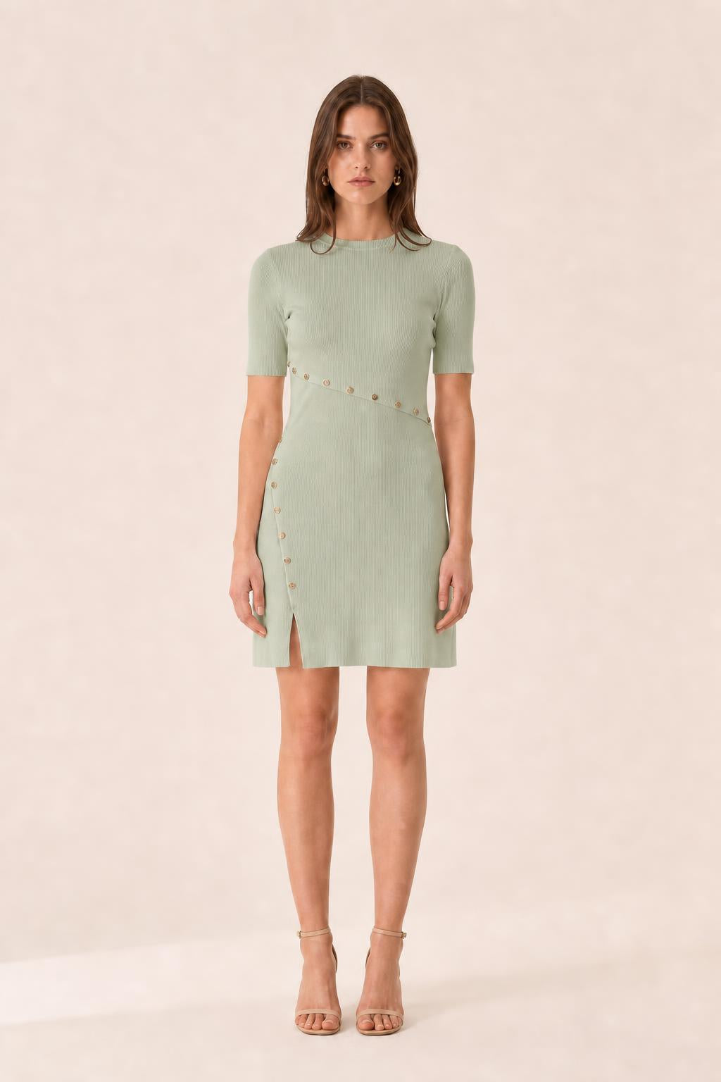 Front view of woman wearing sage green ribbed knit mini dress
