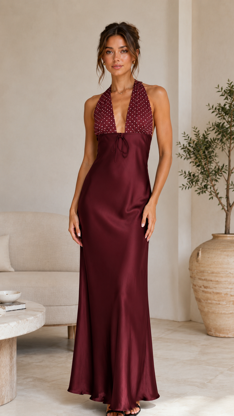 Front view of burgundy halter satin-look maxi dress with polka dot bodice