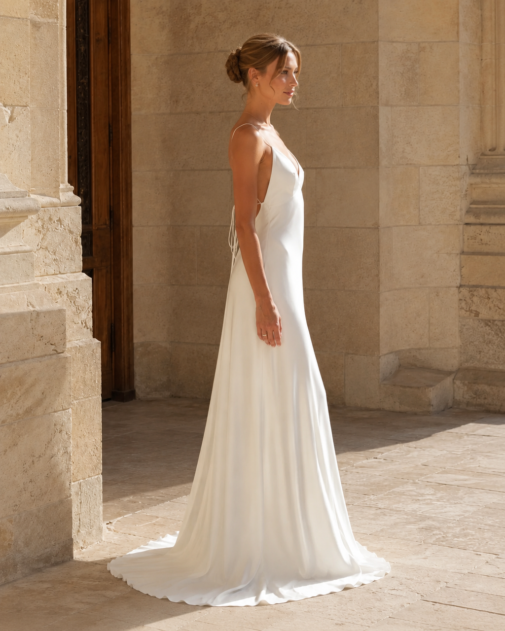 Side view of ivory open back slip maxi dress with fluid silhouette