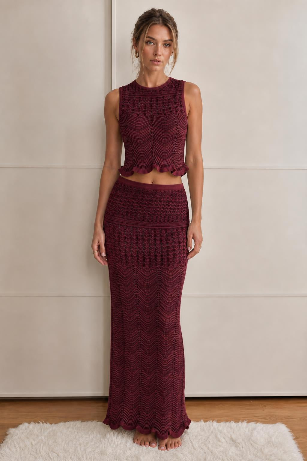 Model wearing burgundy textured knit crop top and maxi skirt set