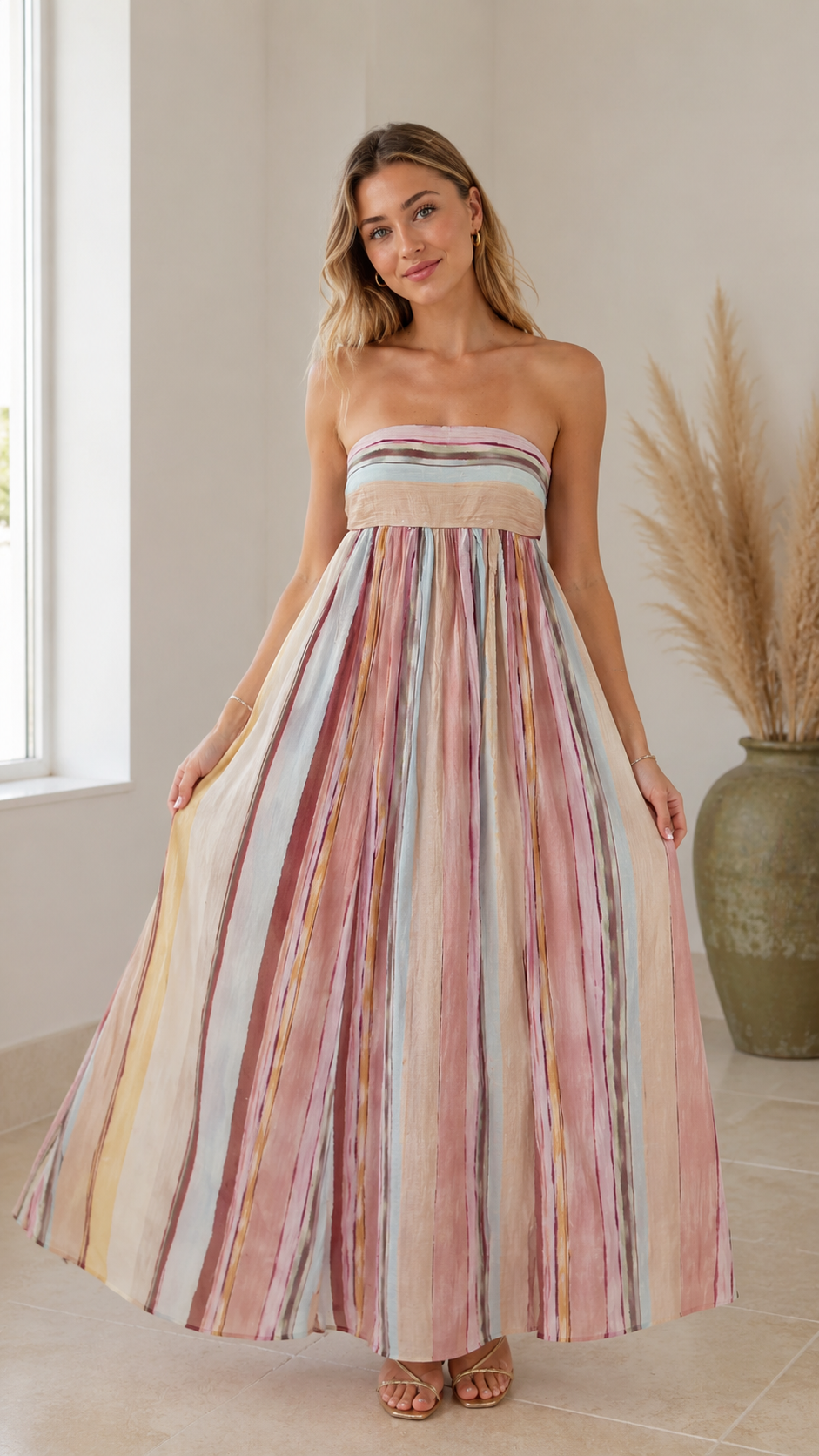 Front view of multicolor striped strapless maxi dress with airy movement