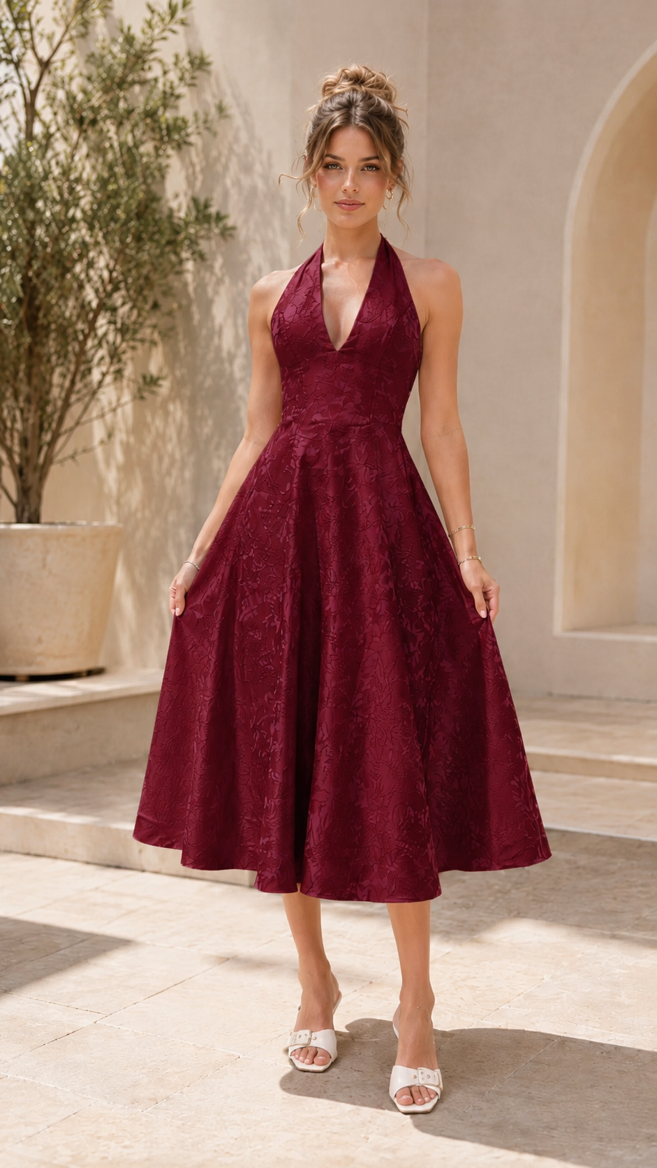 Front view of burgundy halter midi A-line dress with textured finish
