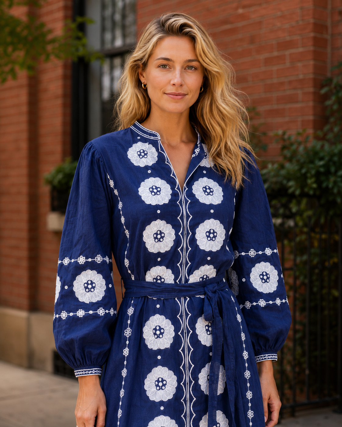 Close-up of cobalt blue embroidered midi dress showing neckline and sleeve detail