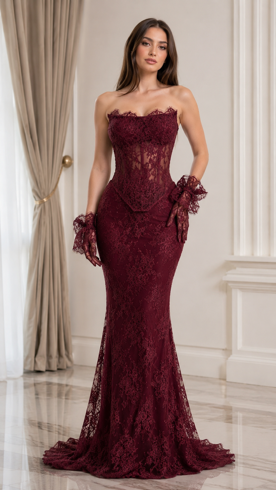 Front view of burgundy strapless lace mermaid gown with sheer corset detail and floor-length hem