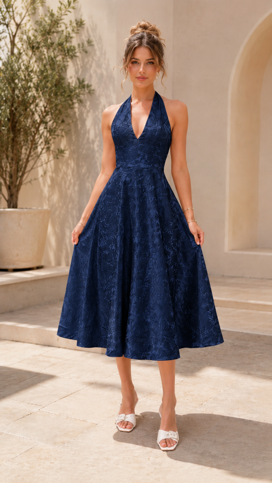 Front view of navy halter midi A-line dress with textured finish