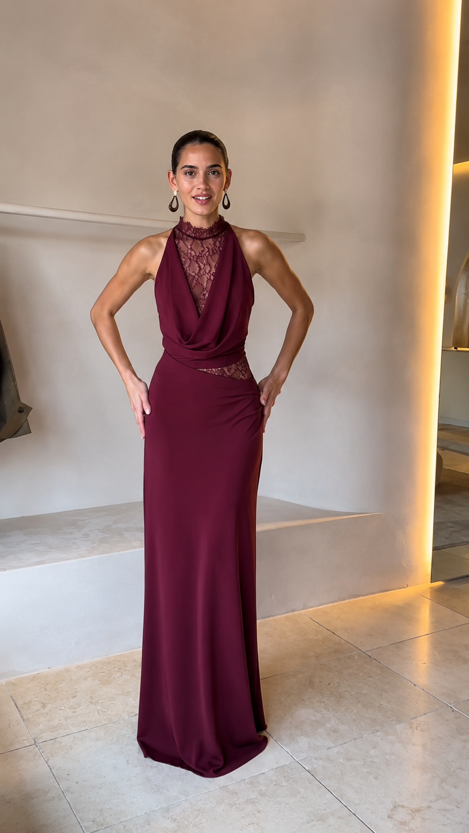 Front view of burgundy halter lace evening gown with fitted floor-length shape