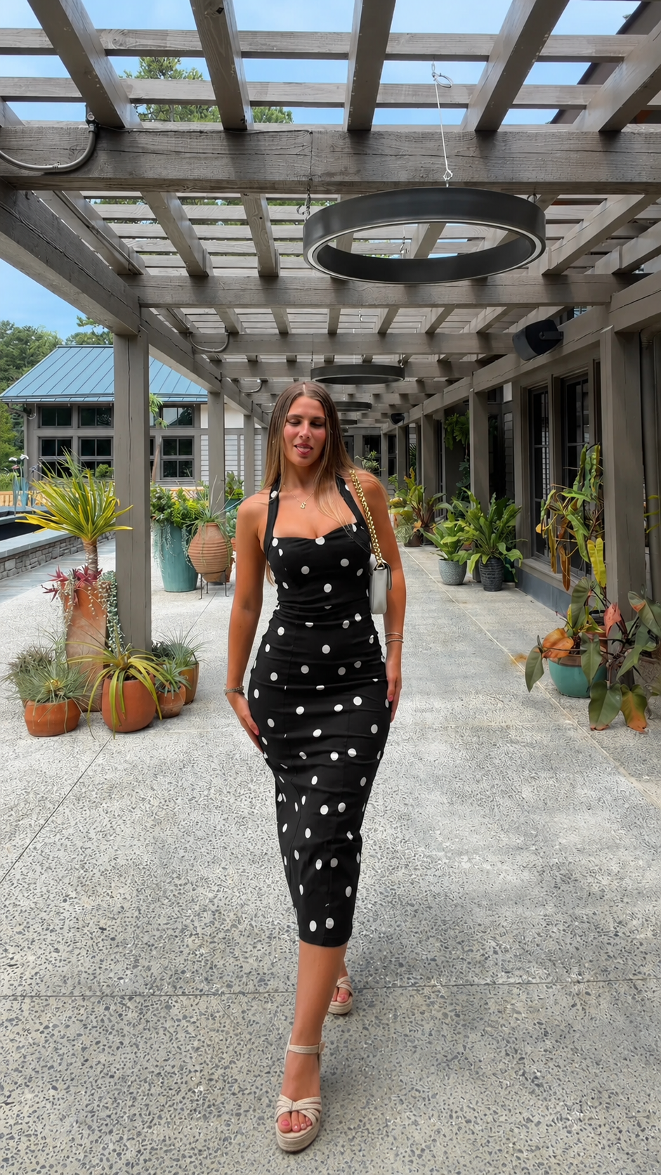 Front view of black polka dot square neck midi dress