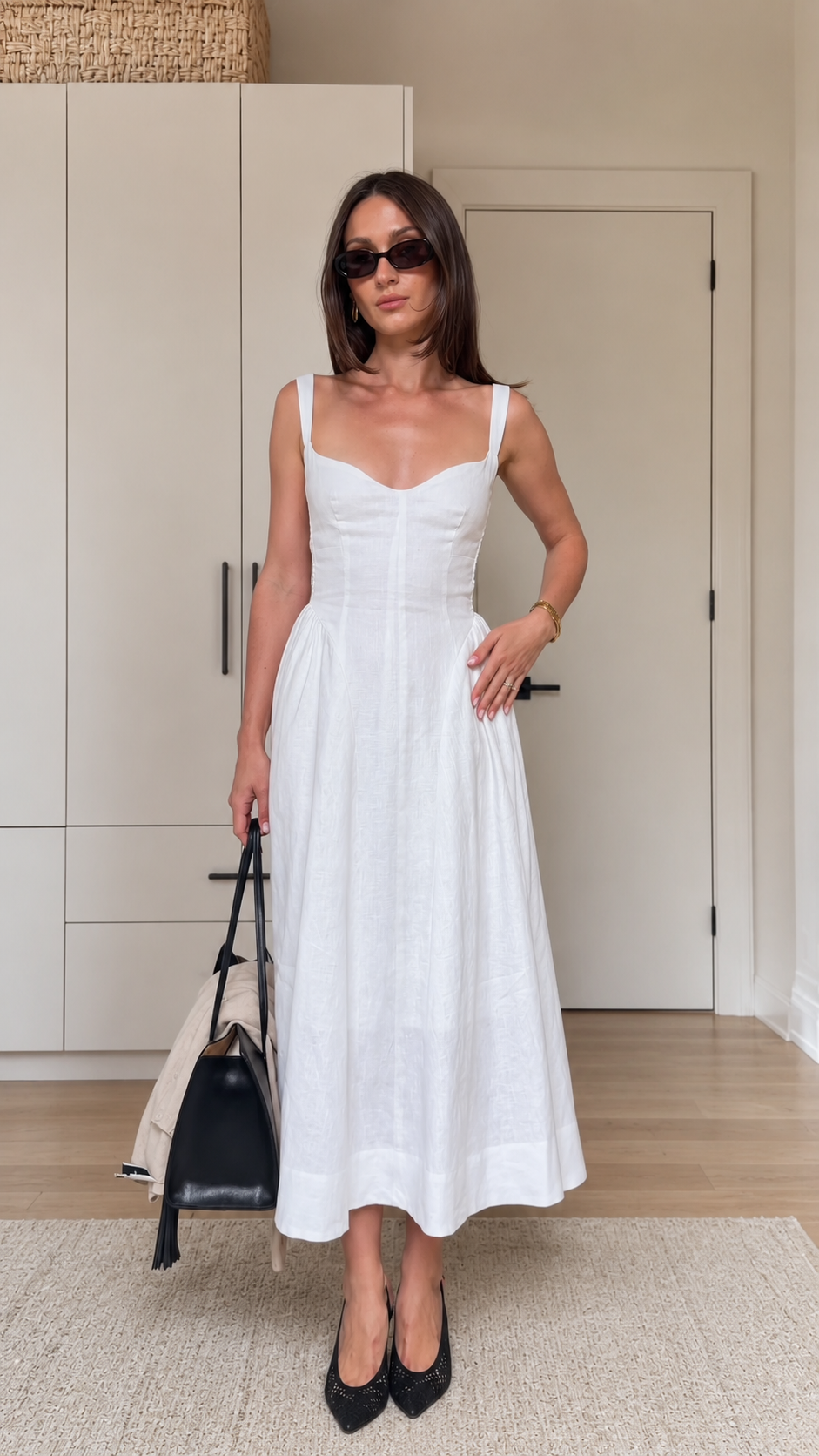 Front view of a white sleeveless sweetheart neck midi dress with a fitted bodice and full midi skirt