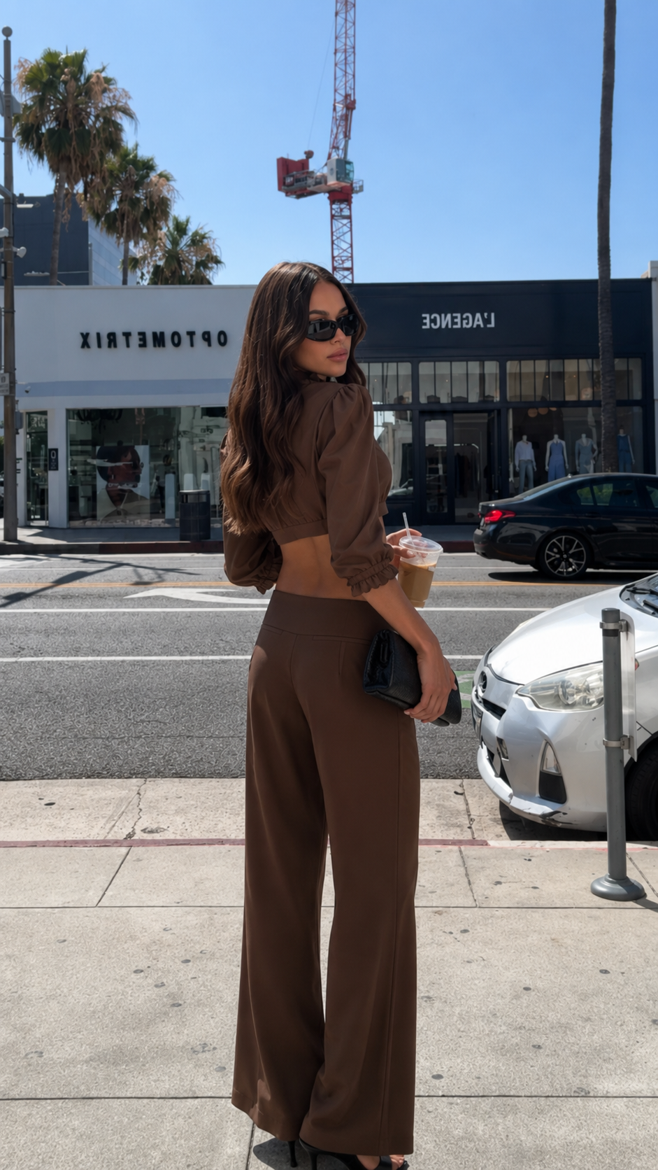 Back view of chocolate brown cropped puff sleeve top and matching wide leg pants